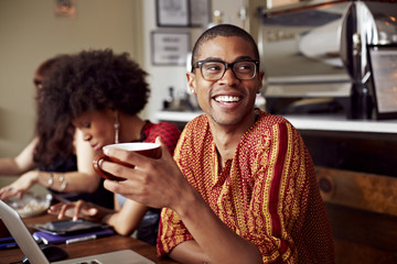 Man having cup of coffee in cafe