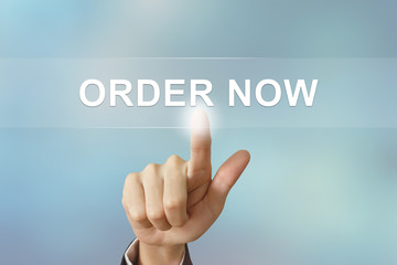 business hand clicking order now button on blurred background