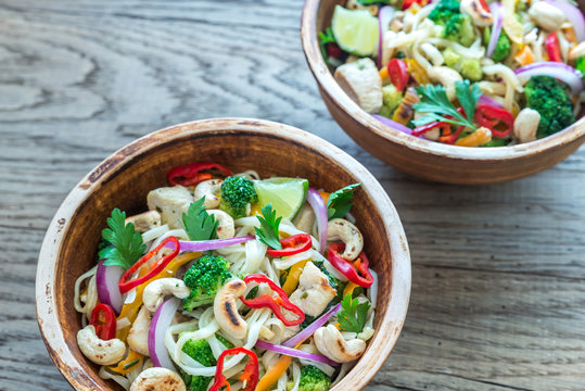 Two bowls of chicken noodle stir-fry