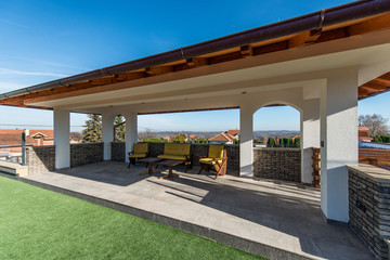 Obraz premium Armchairs on open terrace in luxury villa exterior