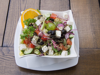 Greek Salad With Feta Cheese On A Wooden Table