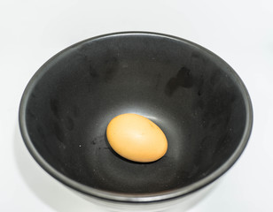 An egg in the black bowl 