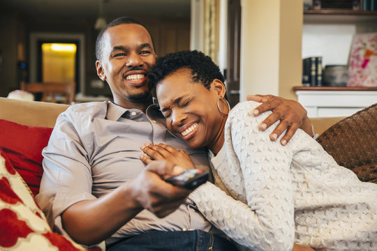 Couple Laughing While Watching Television