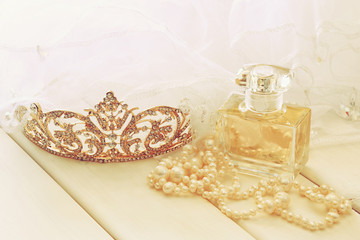 White pearls necklace, diamond tiara and perfume bottle