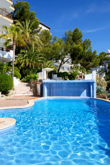 The swimming pool and turquoise water in hotel, Mallorca island, Spain