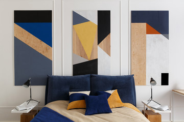 Bedroom interior in modern style with a large bed and paintings