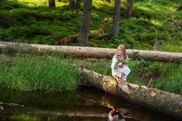 Smiling girl with  bouquet wildflowers