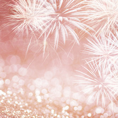 Defocused Rose gold fireworks and bokeh at New Year and copy space. Abstract background holiday.