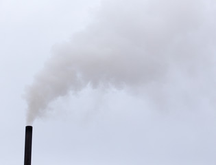 Smoke from a pipe on a cloudy sky