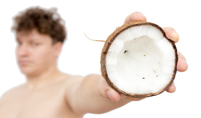 Coconut in a man's hand on a white background