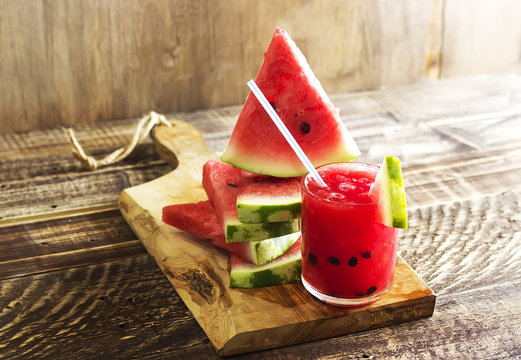 Fresh water melon smoothie on a wooden background, rural style, selective focus