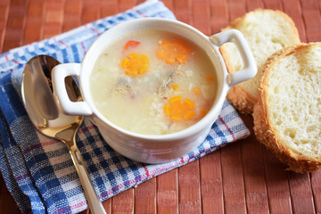 fish soup with carrot in a white plate