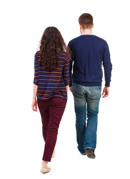 Back view going couple. walking friendly girl and guy holding hands. Rear view people collection. backside view of person. Isolated over white background. Swarthy girl and the bearded man into the