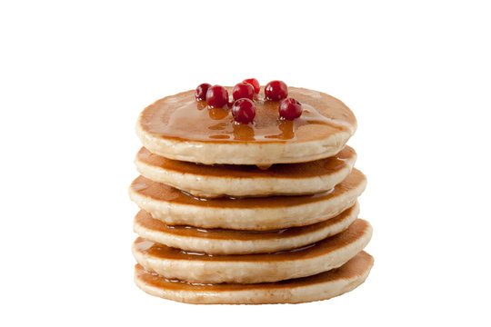 Pancakes with maple syrup and cranberries isolated on white background. Breakfast, snacks.