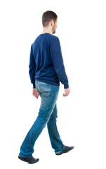Back view of going  handsome man. walking young guy . Rear view people collection.  backside view of person.  Isolated over white background. bearded man in blue pullover goes diagonally.