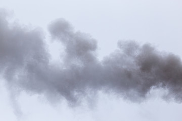 Smoke from a pipe on a cloudy sky