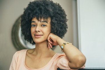 Mixed race woman smiling indoors