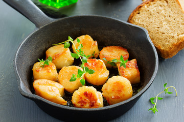 Scallops fried in cream sauce with herbs.