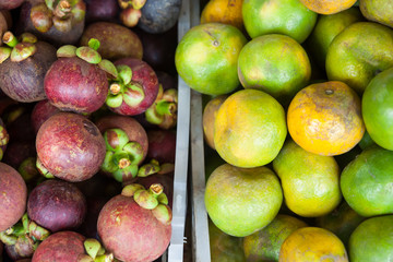 Mixed tropical fruits on local asian market in Thailand in fifty fifty proportion