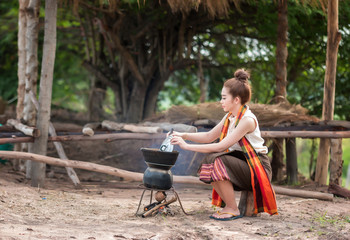 Women are cooking in rural Thailand.