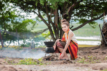 Asian woman are cooking in countryside.