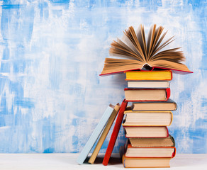 Composition with old vintage colorful hardback books, diary on w