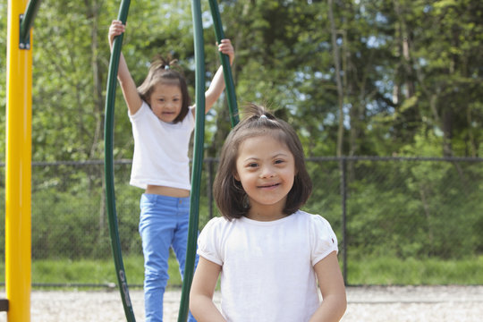 Down syndrome girls smiling on the playground