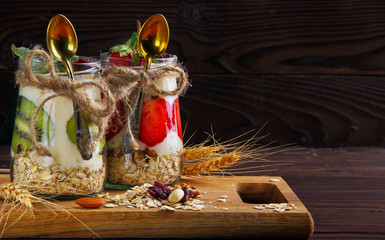 Two jar with hommemade oat flakes with fresh yogurt with kiwi an