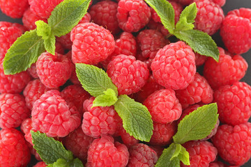 Fresh raspberry with mint leaves background