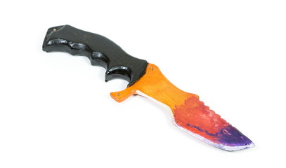 Wooden model of knife on white background