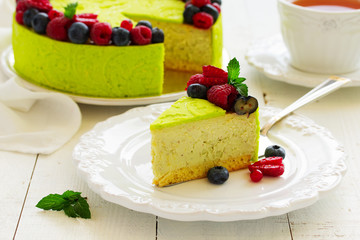 Home pistachio cheesecake with raspberries and blueberries.