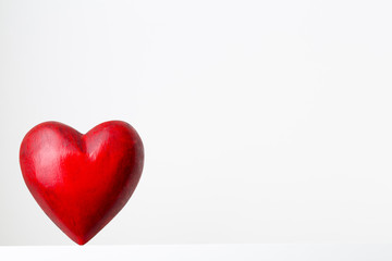 Red heart on the gray metal background.