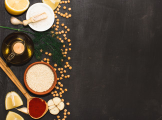 Obraz na płótnie Canvas Ingredients for hummus on a black wooden background