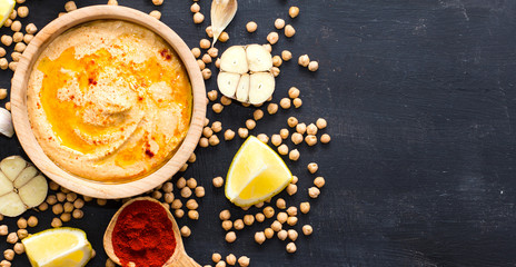 Hummus on a black wooden background