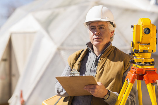 Hispanic surveyor working outdoors