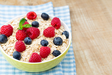 Oatmeal porridge with berries. Raspberries and blueberries.
