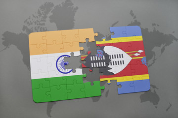 puzzle with the national flag of india and swaziland on a world map background.