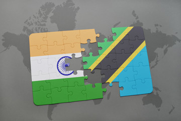 puzzle with the national flag of india and tanzania on a world map background.