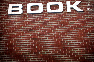Fototapeta na wymiar old brick library with book sign
