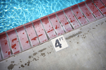 swimming pool deck with depth warning and water