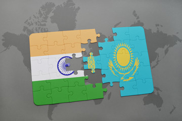 puzzle with the national flag of india and kazakhstan on a world map background.