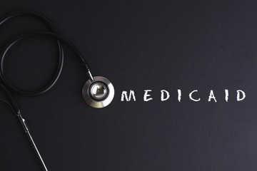MEDICAID  word with stethoscope - health concept. Medical concepT