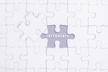 Missing white puzzle with INTERNSHIP word and copyspace area.