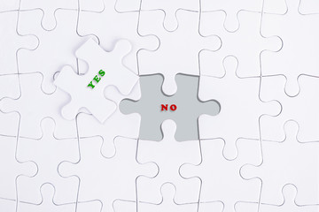 Missing white puzzle with YES NO word and copyspace area.
