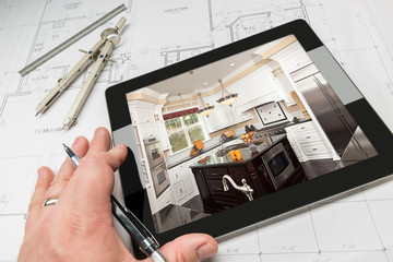 Hand of Architect on Computer Tablet Showing Custom Kitchen Photo Over House Plans, Compass and...