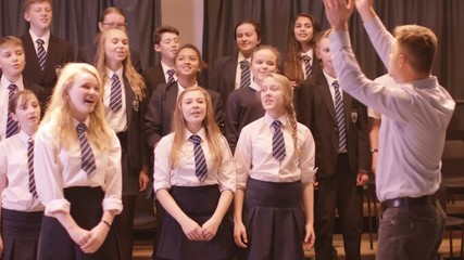  Young students singing in rehearsal for school musical production