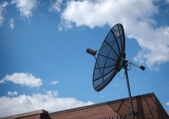 satellite dish on brick building