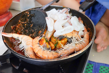 seafood cooking with shrimps and squid