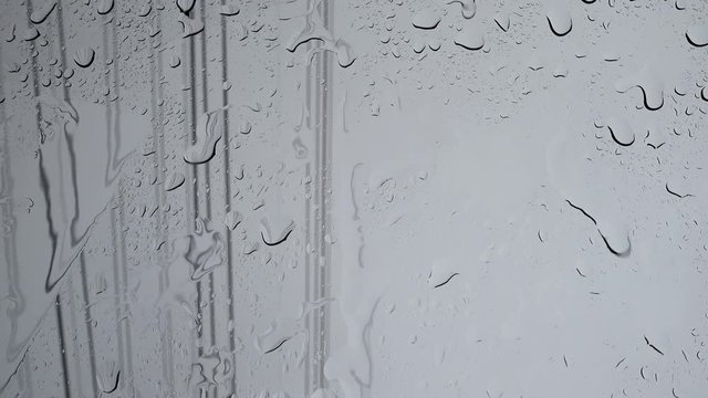Rain running down or shower on window background, closeup shot High quality footage in 4K