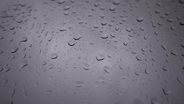 Rain running down or shower on window background, closeup shot High quality footage in 4K